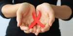 Woman holding red ribbon