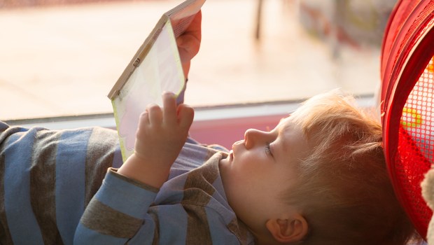 Little boy reading a book