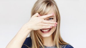 YOUNG BLOND WOMAN SMILING