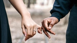 COUPLE HOLDING HANDS