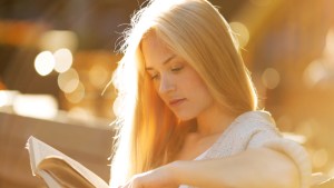 girl sitting and reading book