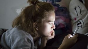 web2-teenage-girl-looks-on-her-smartphone-in-bed-during-the-night-shutterstock_547499824.png