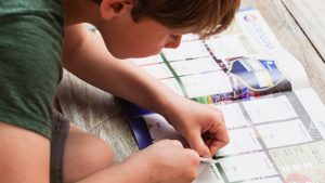 CHILD COLLECTING STICKERS