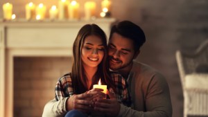 COUPLE AT HOME HOLDING CANDLE