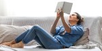 WOMAN, READING, SOFA