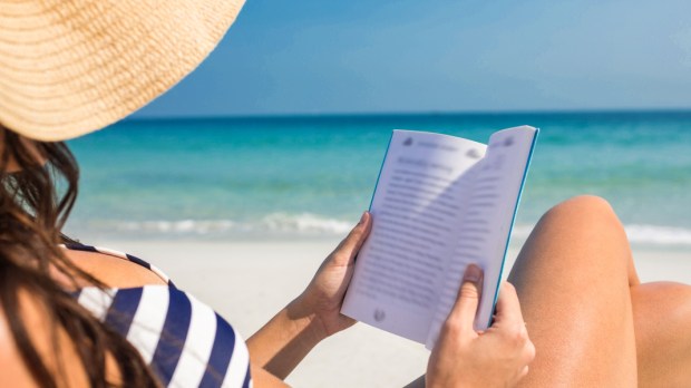 WOMAN READS BOOK,