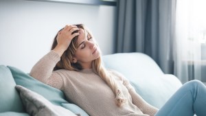 WOMAN SITTING ON COUCH