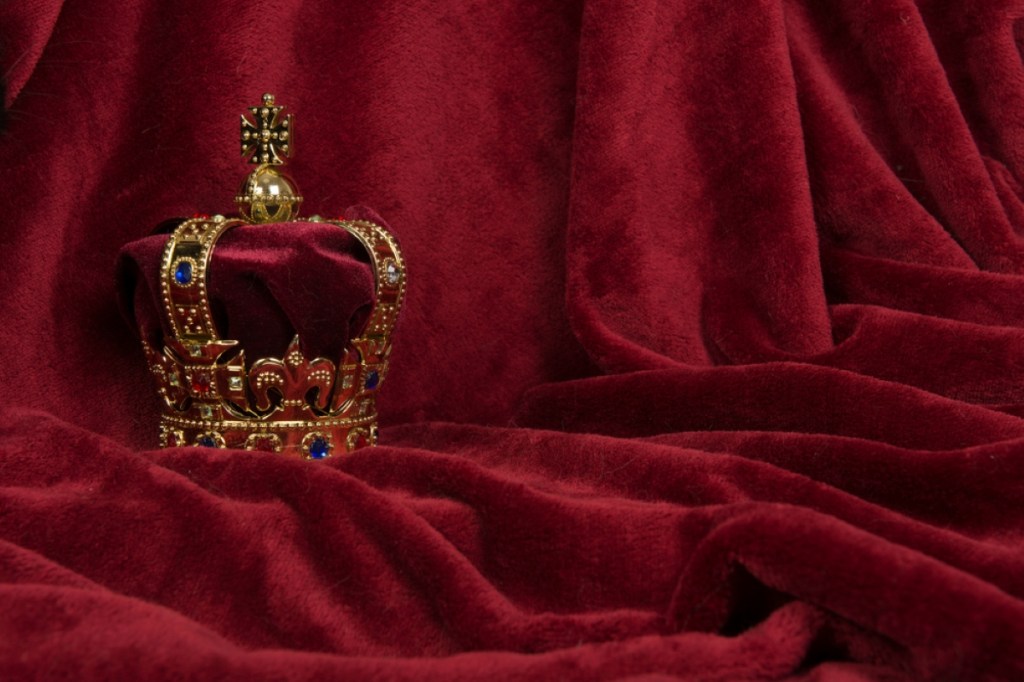 Golden crown on a red velvet background