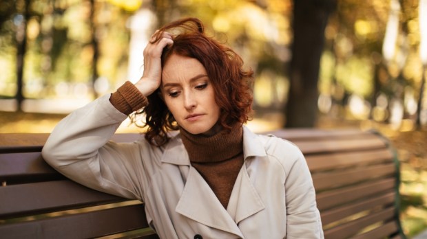 Tired woman sitting on a bench