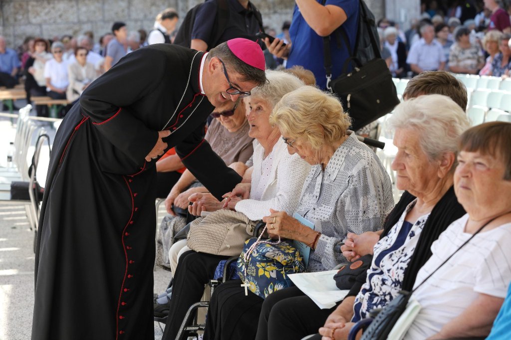 Bishop Maksimilijan Matjaz with the elderly people at Brezje