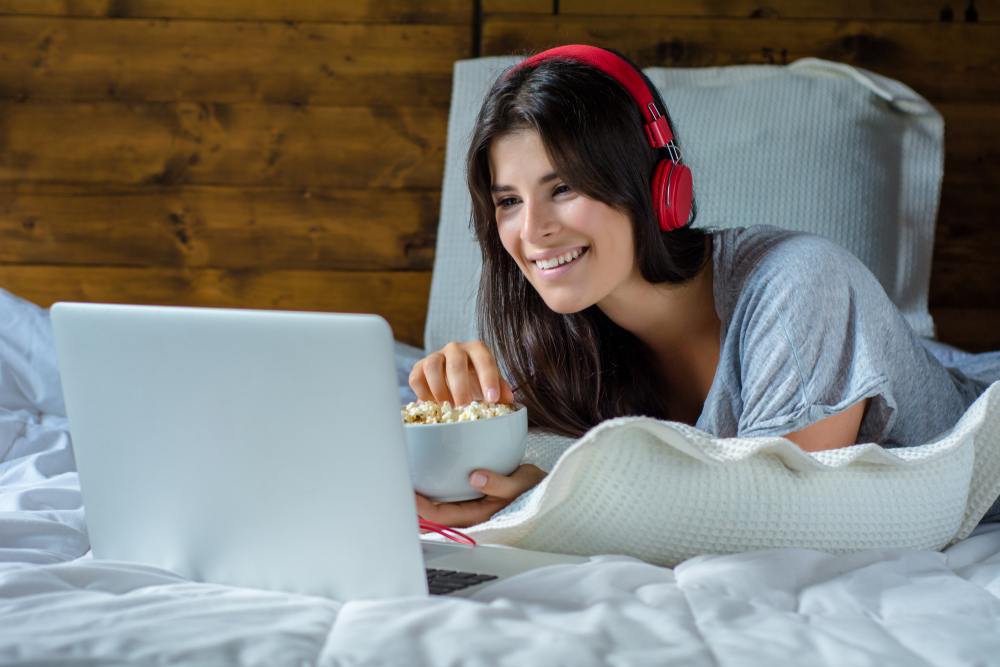 Girl watching movie in bed