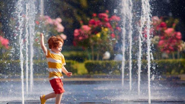 happy boy playing with water