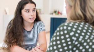 Mother Having Serious Conversation With Teenage Daughter At Home