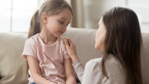 single parent mother comforting sad small sullen kid daughter