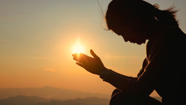 Woman raising her hands in worship