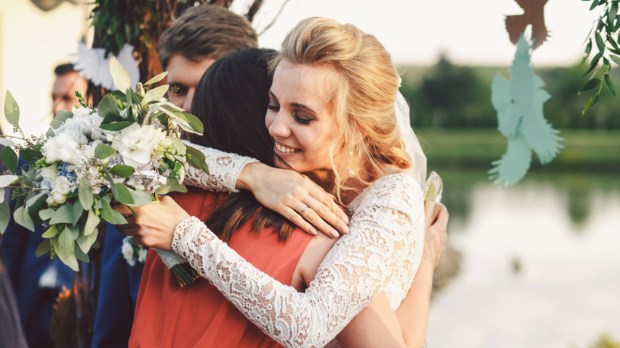 Bride hugging friend