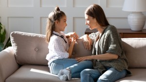 Caring mother and little daughter chatting