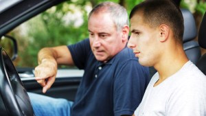 Father teaching his son how to drive