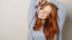 Happy carefree young redhead woman