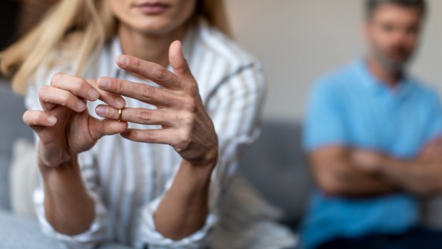 Unhappy middle aged european lady takes off ring