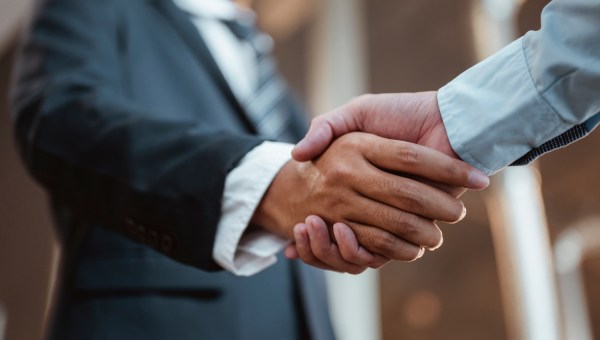 Commander handshaking new employee congratulating with starting a new job