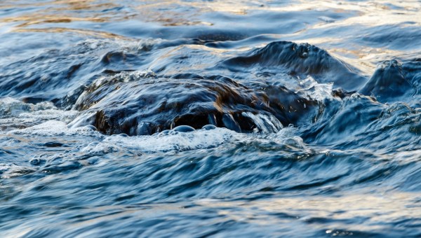 flow of water and spray from a stone close up