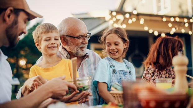 Happy Senior Grandfather Talking and Having Fun with His Grandchildren