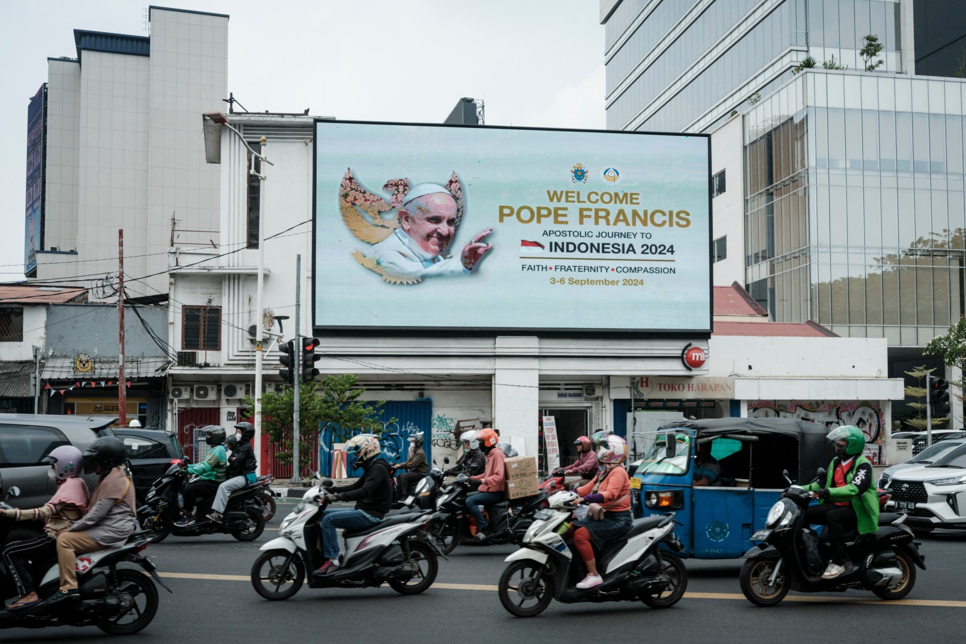 A welcome message is displayed on an electric billboard prior to the arrival of Pope Francis near the Vatican embassy in Jakarta