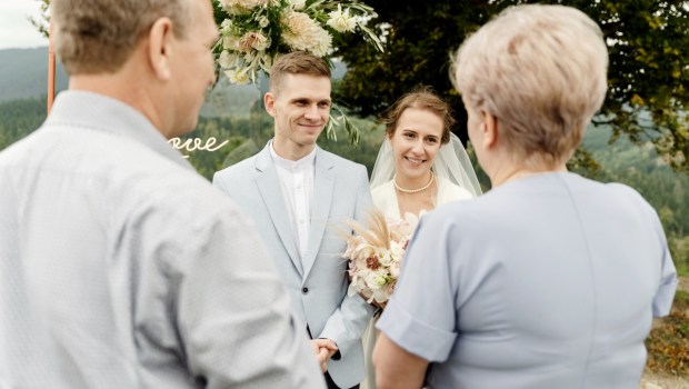elderly parents with a young wedding couple after a wedding ceremony